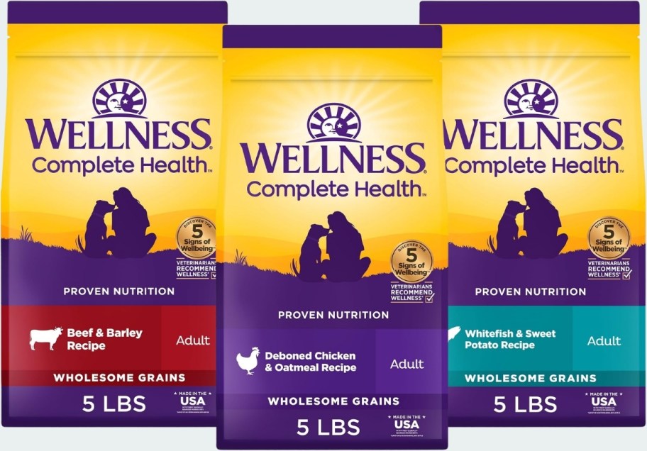 3 bags of wellness dog food in different flavors