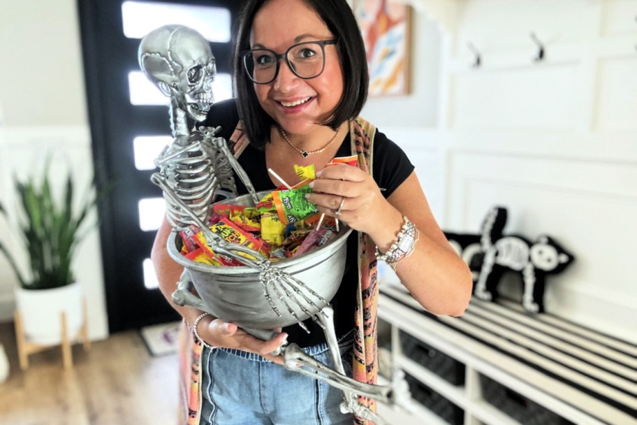 woman holding a diy halloween candy skeleton bowl 