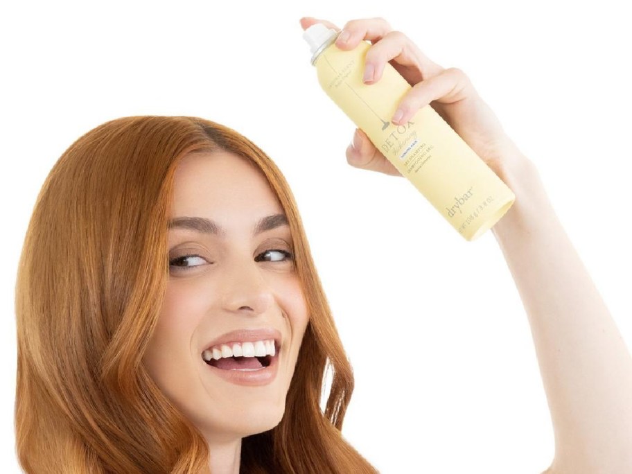 woman spraying dry bar spray