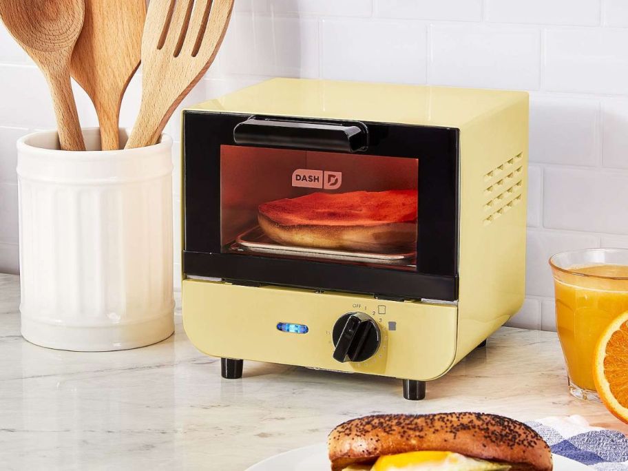 yellow toaster oven displayed on top of a kitchen counter