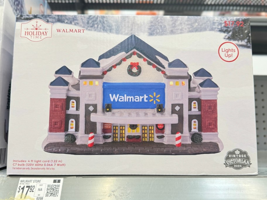 a box with a Walmart store Holiday Village piece on a shelf 