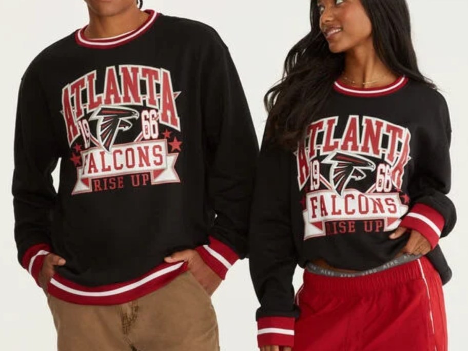 man and woman wearing black, red, and white Atlanta Falcons sweatshirts