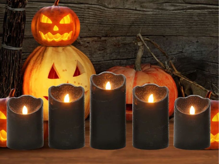 5-Piece LED Pillar Candles Set lit in front of halloween display