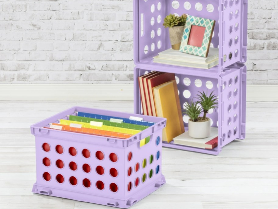 3 bright purple plastic box storage cubes containing items