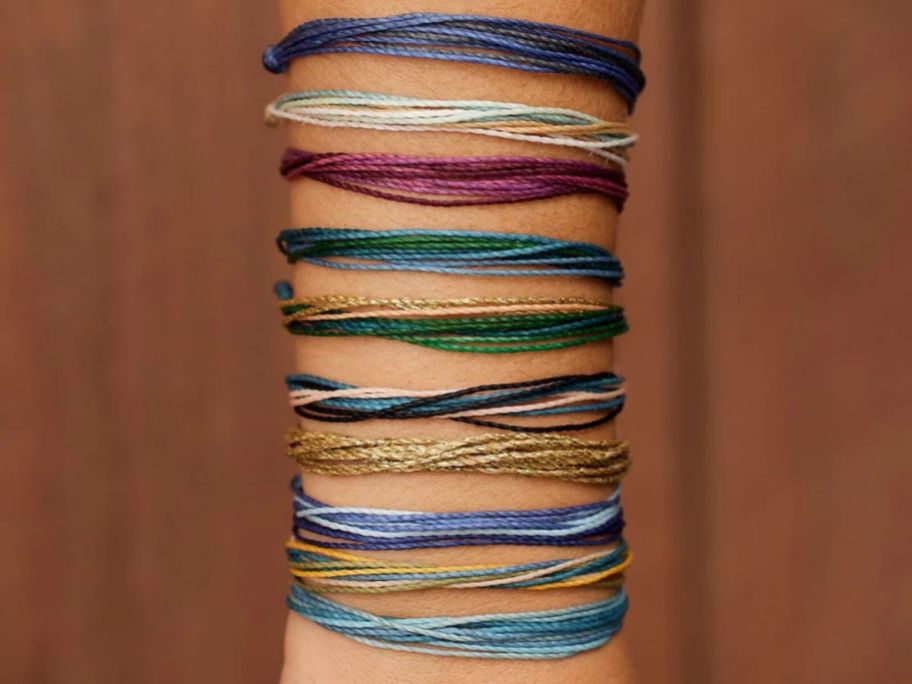 a girls forearm with a bracelet stack
