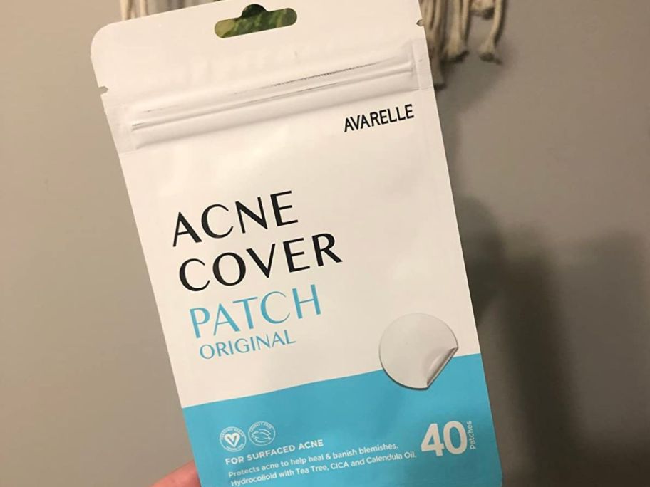 hand holding a pack of Avarelle Acne Patch Covers