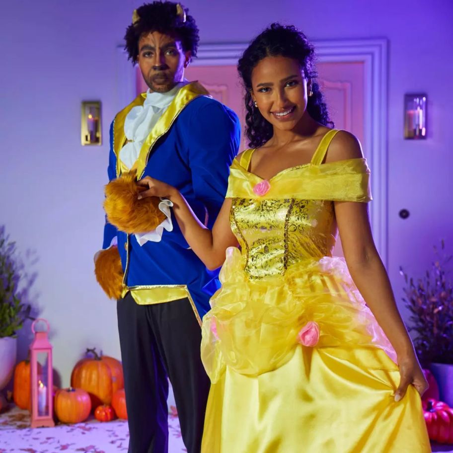 a woman in a belle costume and a man in a beast costume 