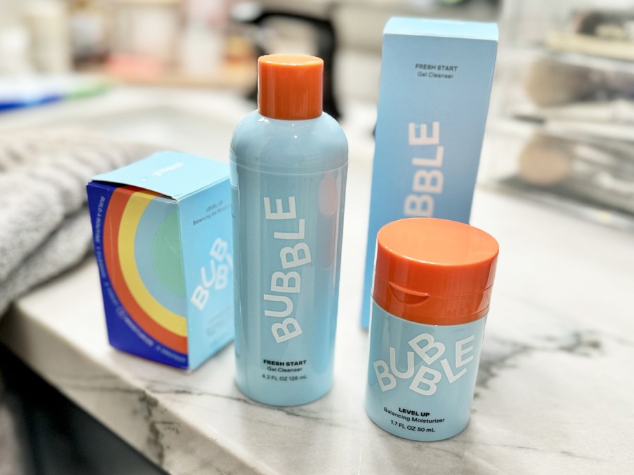 blue bottles of bubble skincare products on bathroom counter