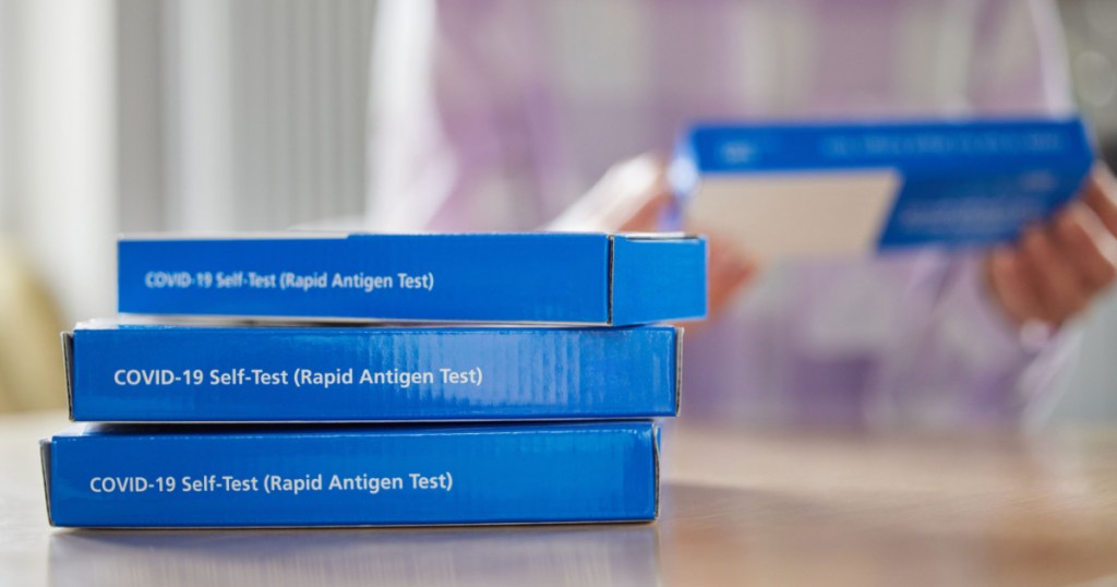 blue boxes of at-home covid tests on counter