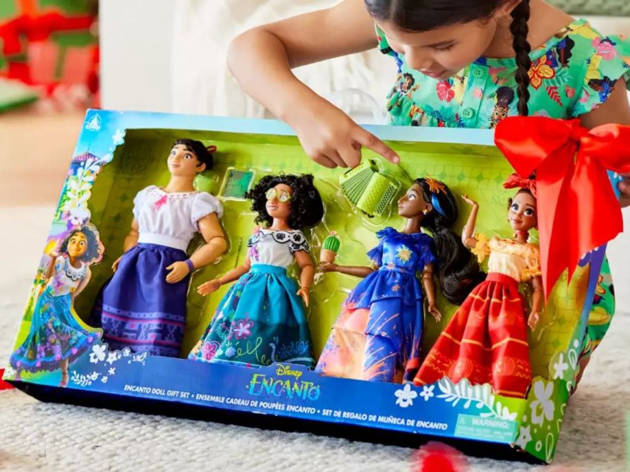 Little girl opening a Disney Encanto Doll Set on Christmas