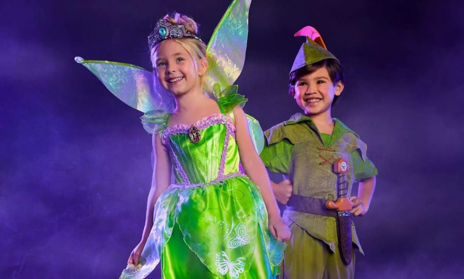a little girl in a Tinkerbell costume and a little boy in a peter pan costume