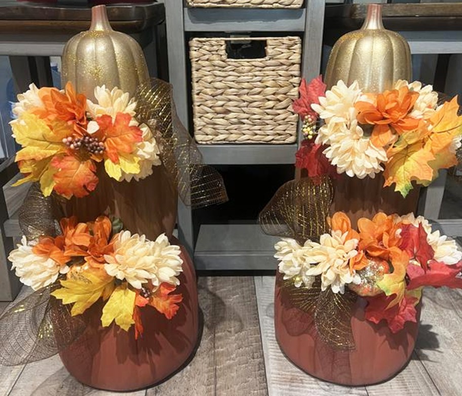 stack of pumpkins decorated with flowers