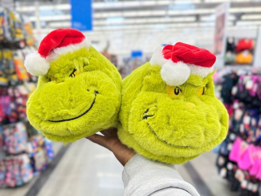 Dr. Seuss The Grinch Holiday Adult Slippers in hand in store