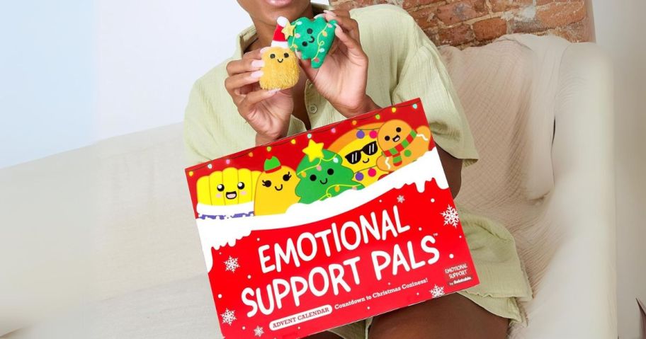 woman with Emotional Support Plush Advent Calendar on lap and she's holding a couple of plushies