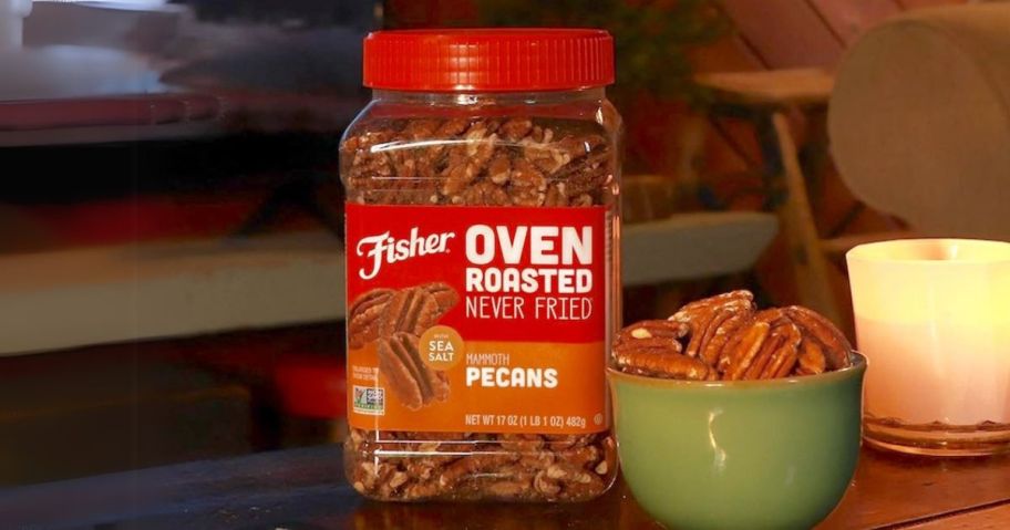 Fisher Oven Roasted Never Fried Mammoth Pecans 17oz canister on table next to bowl of pecans