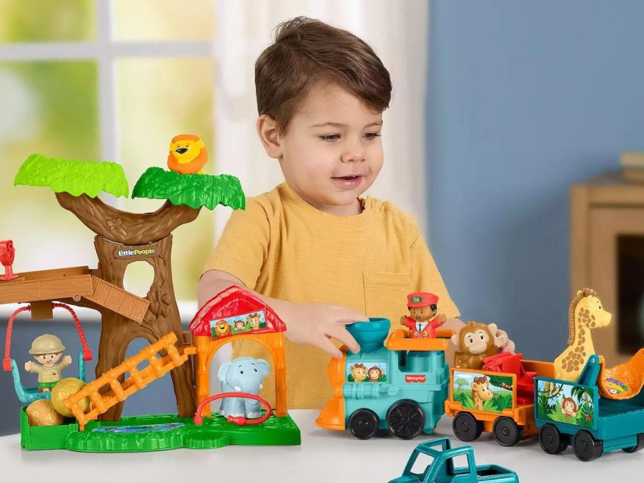 boy playing with Fisher-Price Little People Wildlife Train & Trek Toddler Gift Set w/ Animals & Figures