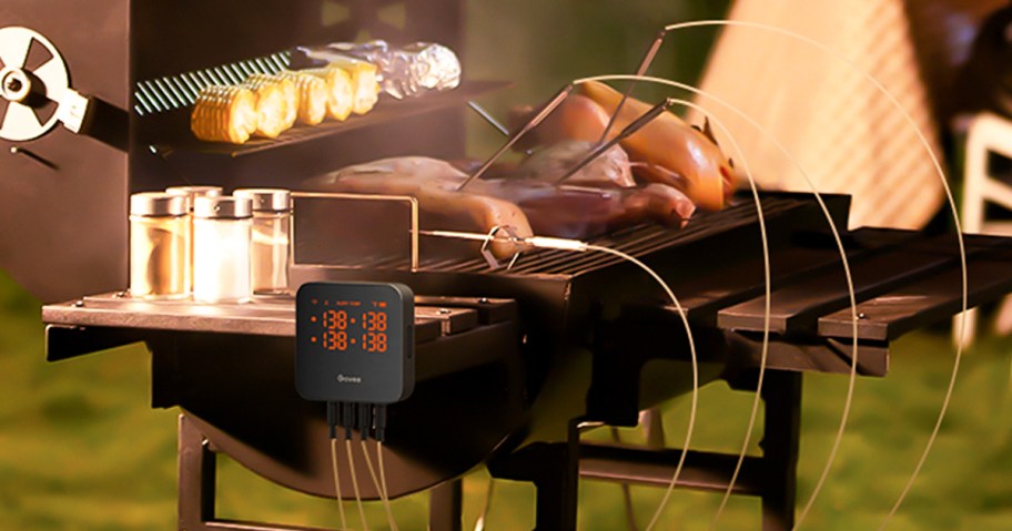 meat thermometer with 4 probes stuck into foods on grill