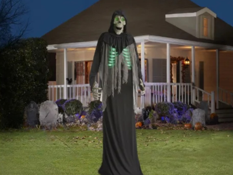 large animatronic grim reaper outside a house