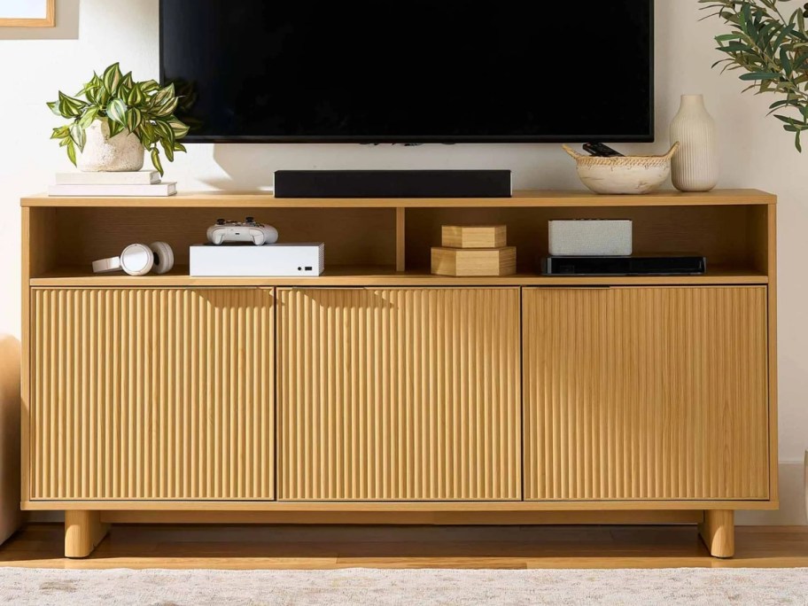 a light wood tone fluted style large TV stand