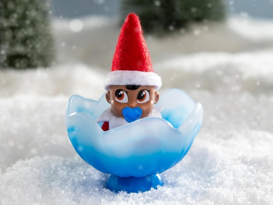 Elf on the Shelf Frost Pip baby elf in a blue flower cradle