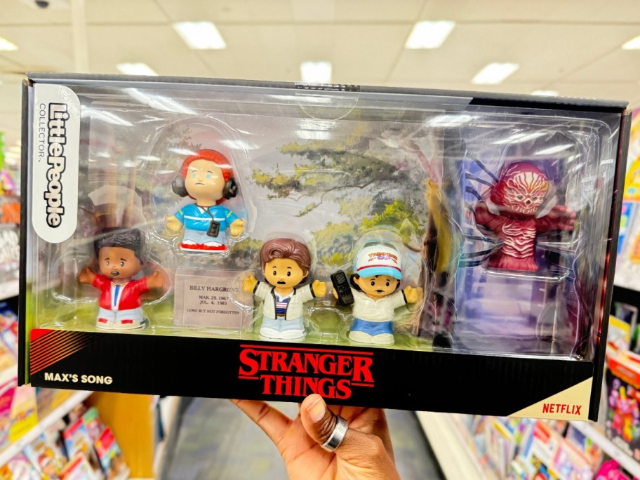 hand holding a Fisher-Price Little People Stranger Things Max's Song Set in a store