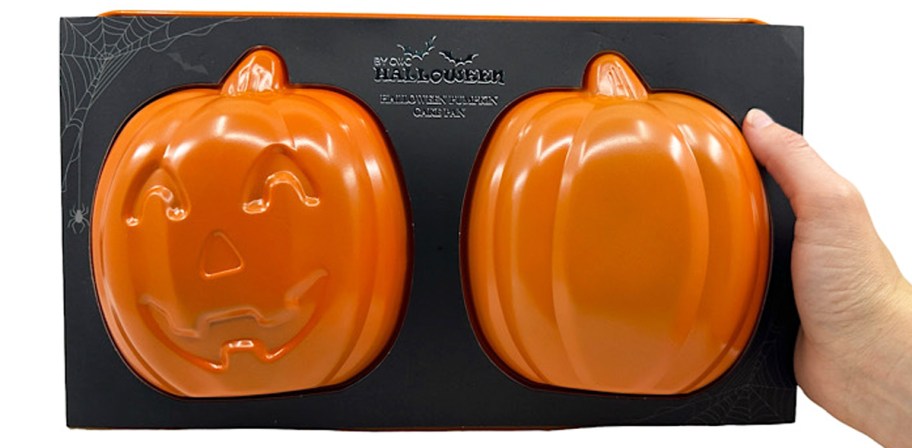 hand holding a pumpkin cake pan 2-piece set