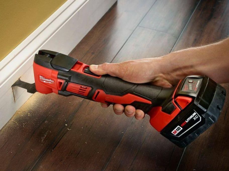 Hand using a Milwaukee M18 18V Lithium-Ion Cordless Multi-Tool