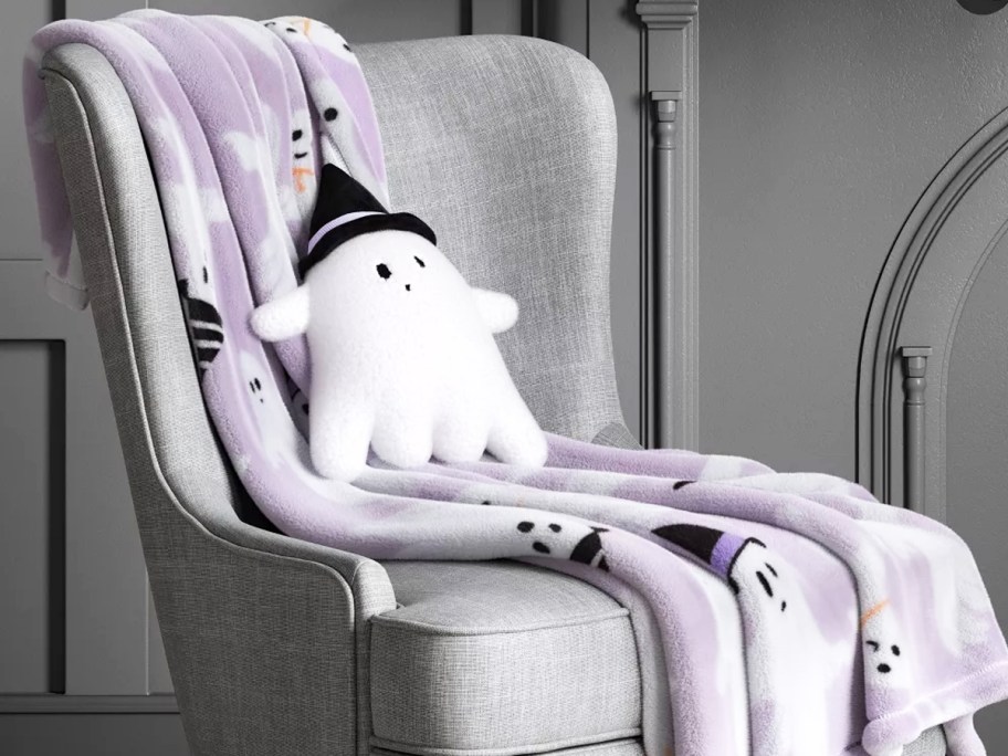 purple ghost print throw blanket on a chair with a ghost pillow