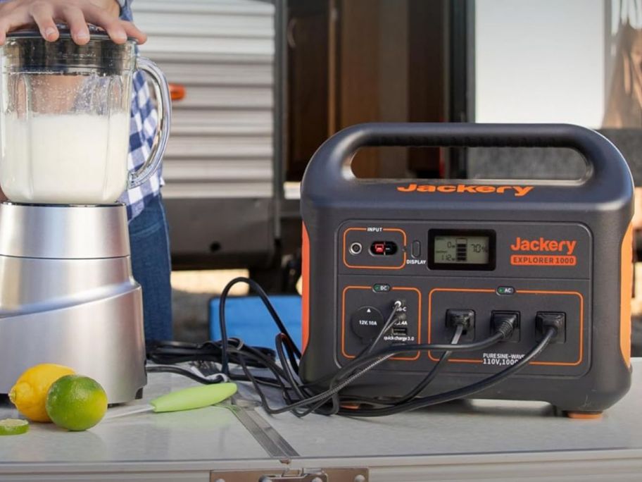 Jackery Explorer Portable Power Station charging multiple items on table