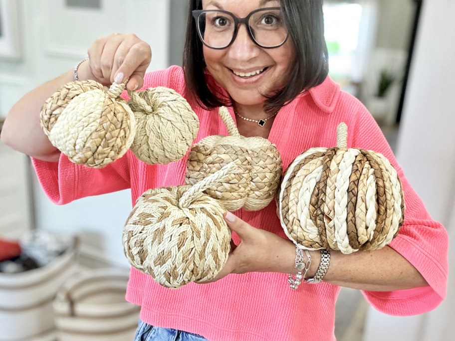 woman holding a set of rattan pumpkins