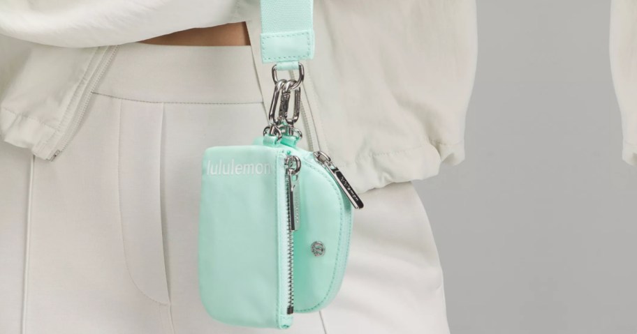 person holding Lululemon Dual Wristlet light blue