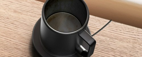 black coffee mug on warming coaster