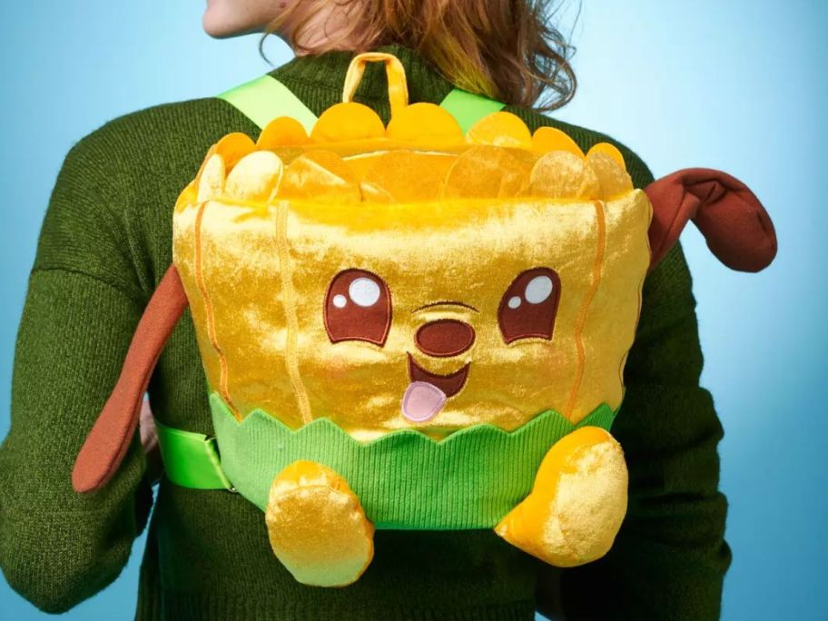 Woman wearing a Sensational Snacks Pluto Ramen Disney Munchlings Plush Backpack