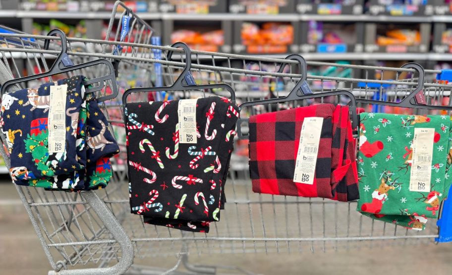 4 pair of velour legging in various holiday prints displayed o the side of a shopping cart on a store aisle