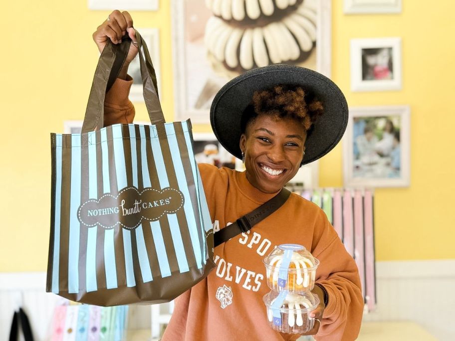 A person holding a Nothing Bundt Cakes Bag and 2 cakes