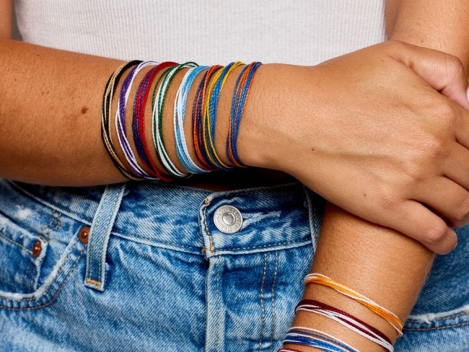 Two arms wearing Pura Vida Bracelets