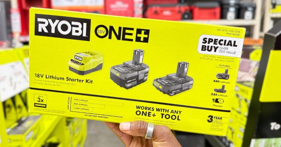 Hand holding up a Ryobi One+ Lithium Bettery Starter Kit