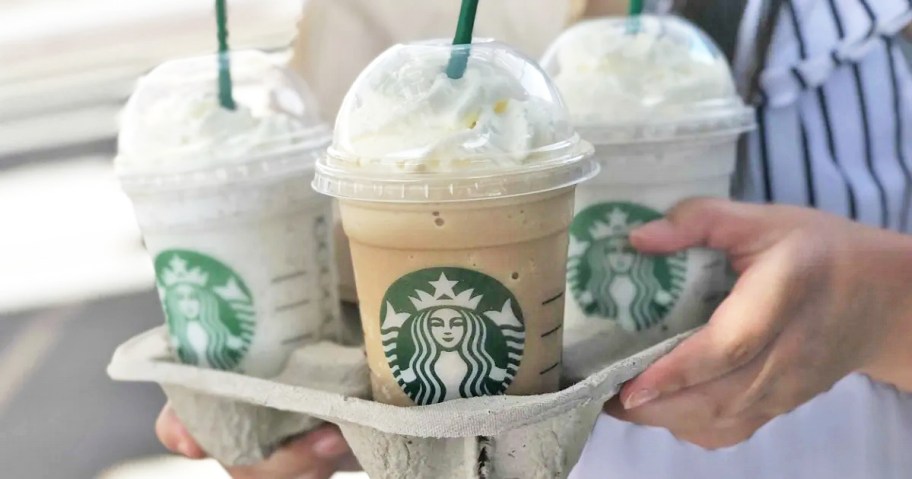 three starbucks drinks in drink holder