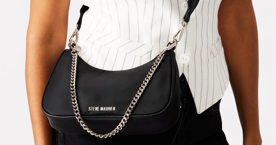 women with a black steve madden purse