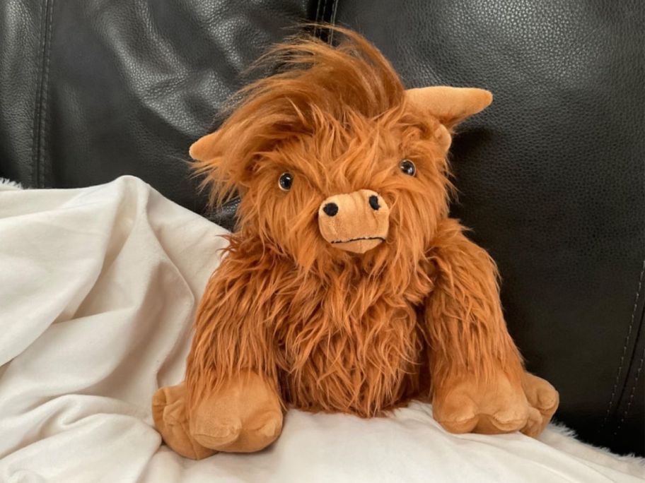 A plush highland cow on a sofa