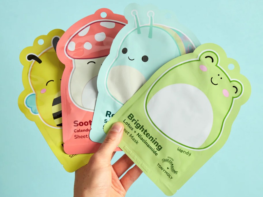 hand holding up 4 TONYMOLY Squishmallows face masks