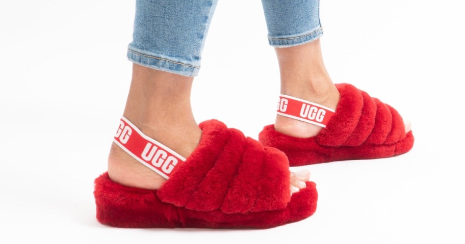 view of woman's feet wearing UGG Women’s Fluff Yeah Slide Slippers in samba red