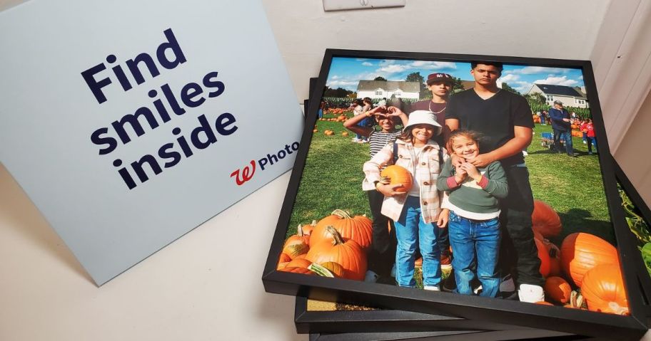 A stack of Walgreens TilePix next to a Walgreens photo box