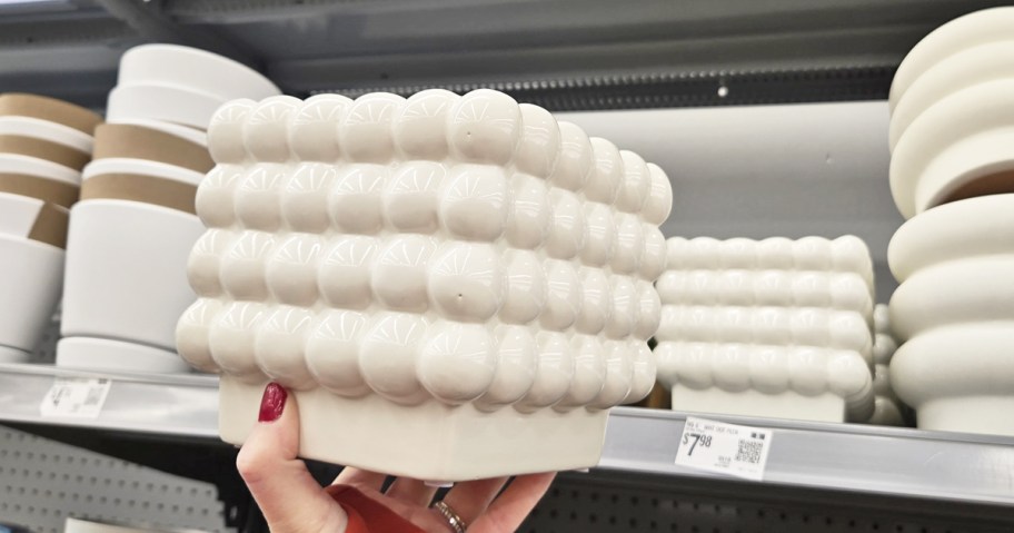 hand holding up a white bubble planter in store