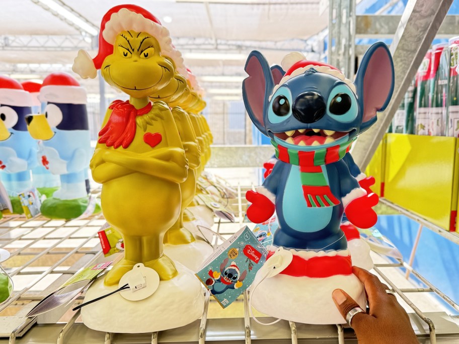 Grinch and Stitch christmas blow molds on store shelf