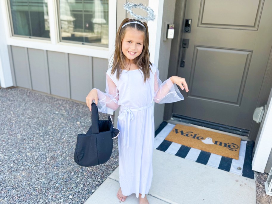 girl wearing a white angel halloween costume