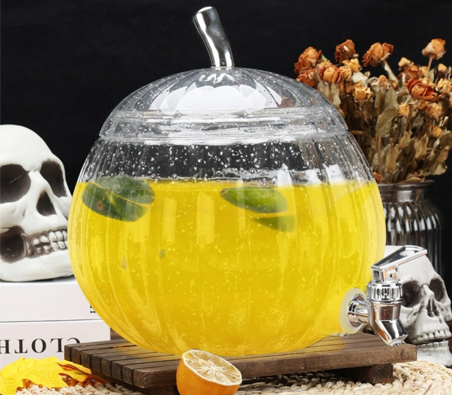 yellow drink inside a glittery acrylic pumpkin beverage dispenser