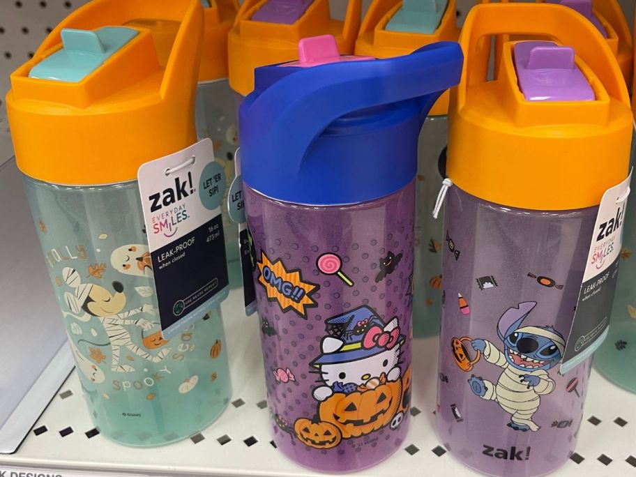 3 Zak Designs Plastic Halloween Straw Cups on the shelf at Target featuring Mickey Mouse, Hello Kitty and Stitch