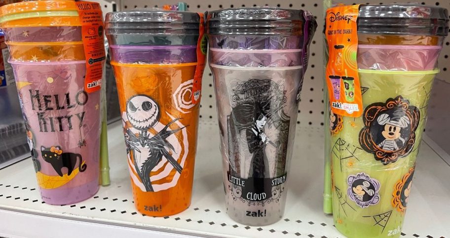 4 different styles of Zak Halloween Cold Cup 3-packs on a shelf at Target featuring Hellow Kitty, The Nightmare Before Christmas, Wednesday and Mickey Mouse
