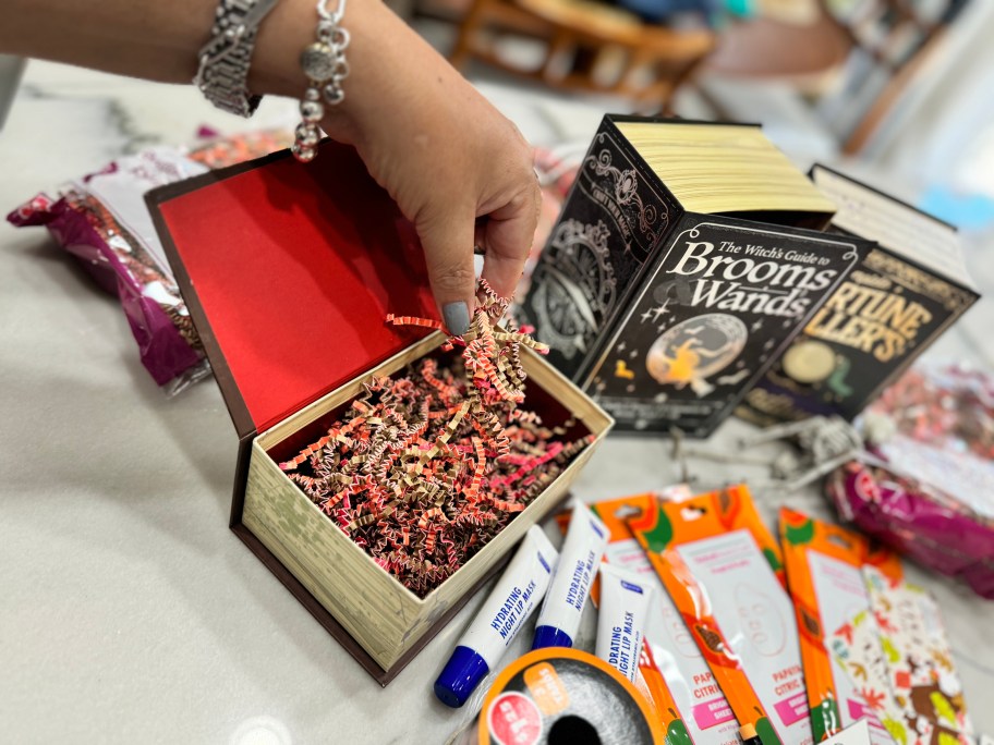 adding paper grass to halloween book box